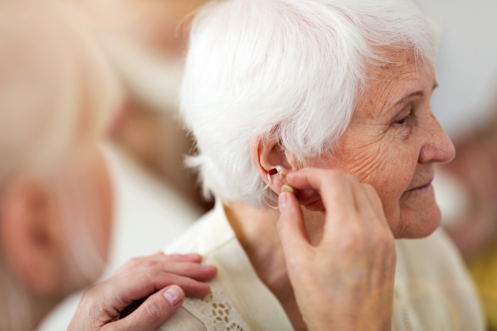senior with sensorineural hearing loss being fit for a hearing aid