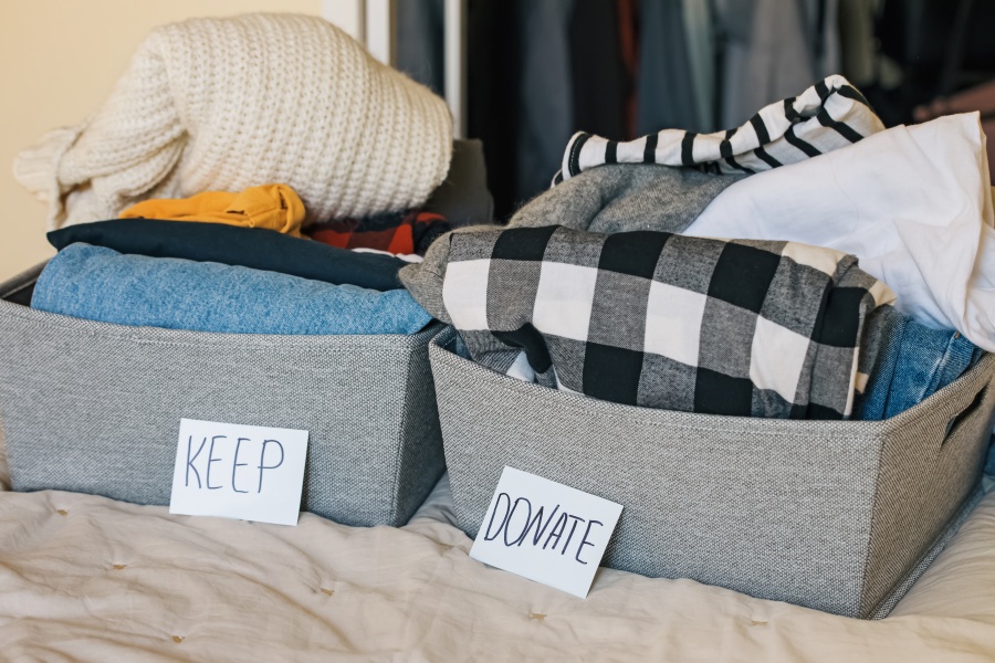 box of clothes labeled keep and donate